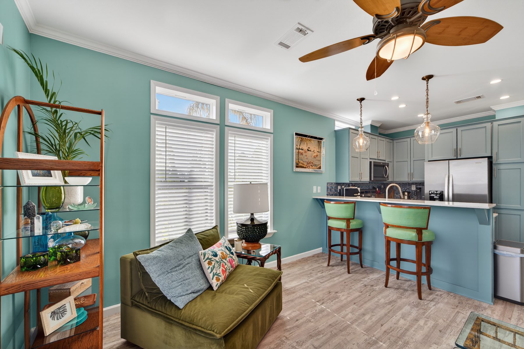 Living room and kitchen with palm fan and bar seating