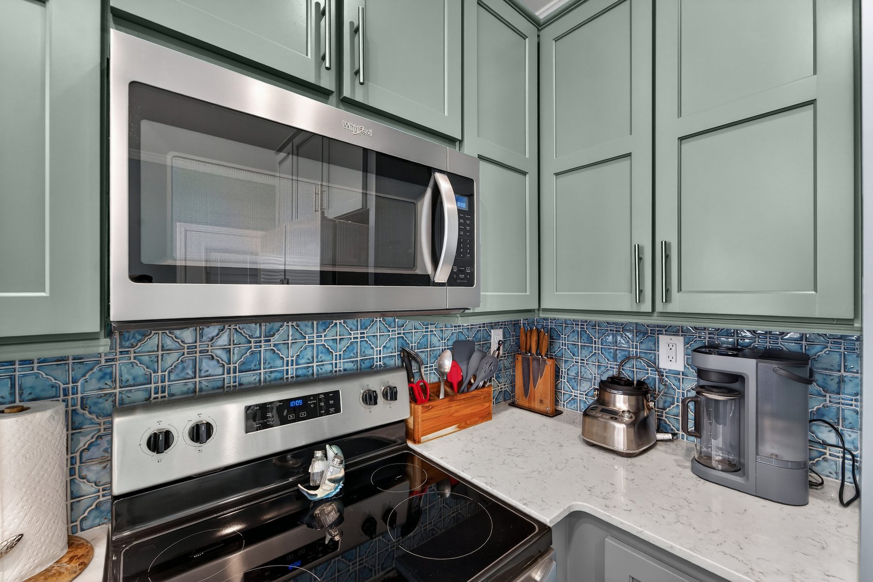 Kitchen close-up with blue mosaic backsplash and stainless appliances