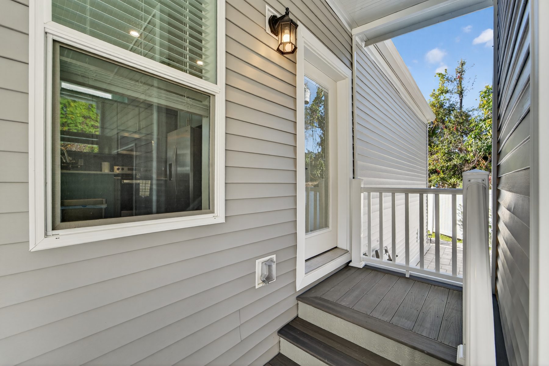 Carport-side entry with deck and lantern